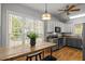 Eat-in kitchen with light gray cabinetry, stainless appliances and large window with backyard views at 128 Madison Ct, Siler City, NC 27344