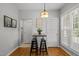Eat-in kitchen with light fixture, table, chairs, backyard views and wood flooring at 128 Madison Ct, Siler City, NC 27344