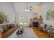 This room features a fireplace, a sofa, and a ceiling fan at 128 Madison Ct, Siler City, NC 27344
