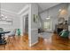 Open-concept living room featuring hardwood floors, a stone fireplace, and large windows for plenty of natural light at 128 Madison Ct, Siler City, NC 27344