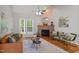 Bright living room showcasing a stone fireplace, hardwood floors, and large window for ample natural light at 128 Madison Ct, Siler City, NC 27344
