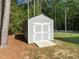 This backyard features a storage shed with double doors for all your outdoor tool and equipment needs at 128 Madison Ct, Siler City, NC 27344