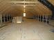 Unfinished attic space is open and bright with exposed rafters and underlayment at 1444 Old Apex Rd, Cary, NC 27513