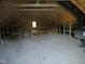 Large unfinished attic space with exposed wooden beams offering great storage or renovation potential at 1444 Old Apex Rd, Cary, NC 27513