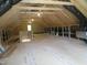 Spacious unfinished attic with exposed rafters, a small window and some electrical work in progress at 1444 Old Apex Rd, Cary, NC 27513