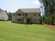 Large, manicured backyard showcasing the home's rear facade and outdoor space at 1444 Old Apex Rd, Cary, NC 27513