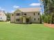 Lush green backyard with a well maintained lawn surrounded by natural landscaping, offering a serene outdoor space at 1444 Old Apex Rd, Cary, NC 27513
