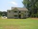 Expansive backyard features a lush lawn and the rear of a well-maintained two-story home at 1444 Old Apex Rd, Cary, NC 27513