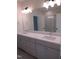 Bright bathroom features a double sink vanity with modern faucets and a glass enclosed shower at 1444 Old Apex Rd, Cary, NC 27513