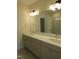 Well-lit bathroom featuring a dual sink vanity with sleek fixtures and a glass-enclosed shower in background at 1444 Old Apex Rd, Cary, NC 27513