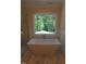 Bright bathroom featuring a soaking tub with a view of the trees at 1444 Old Apex Rd, Cary, NC 27513