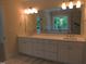 Large bathroom featuring double sinks, spacious countertops, and a soaking tub by a window at 1444 Old Apex Rd, Cary, NC 27513