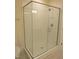 A pristine bathroom with a glass-enclosed shower, modern fixtures, and tile accents at 1444 Old Apex Rd, Cary, NC 27513
