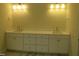 Bright, white bathroom featuring double sinks with lots of storage space at 1444 Old Apex Rd, Cary, NC 27513