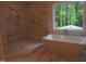 Bright primary bathroom with soaking tub, large window, and marble tile shower at 1444 Old Apex Rd, Cary, NC 27513