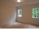 Sunlit bedroom with two windows showcases a bright and airy space at 1444 Old Apex Rd, Cary, NC 27513