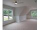 Spacious bedroom featuring two windows, panel molding, plush carpet, and a modern ceiling fan at 1444 Old Apex Rd, Cary, NC 27513