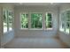 Bright, empty bedroom with multiple windows providing plenty of natural light at 1444 Old Apex Rd, Cary, NC 27513