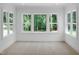 Bright bedroom with large windows overlooking a lush green landscape and a ceiling fan at 1444 Old Apex Rd, Cary, NC 27513