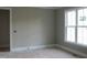 Bright bedroom with large window, neutral walls, and white trim at 1444 Old Apex Rd, Cary, NC 27513
