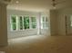 Bright bedroom with three large windows overlooking a wooded area at 1444 Old Apex Rd, Cary, NC 27513