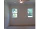 Bright bedroom with two windows offering natural light and scenic views at 1444 Old Apex Rd, Cary, NC 27513