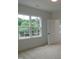 Bright bedroom with plush carpet, a large window with treetop views, and fresh paint at 1444 Old Apex Rd, Cary, NC 27513