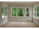 Bright bedroom with large windows overlooking a wooded area at 1444 Old Apex Rd, Cary, NC 27513