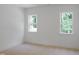 Neutral bedroom space, bathed in light from two large windows, offering a serene and inviting atmosphere at 1444 Old Apex Rd, Cary, NC 27513
