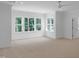 Spacious bedroom with large windows providing ample natural light and scenic views at 1444 Old Apex Rd, Cary, NC 27513