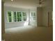 Spacious bedroom with large windows providing natural light and a ceiling fan at 1444 Old Apex Rd, Cary, NC 27513