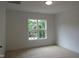 Bright bedroom with plush carpet, a large window, and fresh paint throughout at 1444 Old Apex Rd, Cary, NC 27513