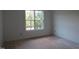 Bright bedroom with a large window showcasing natural light and awaiting personalization at 1444 Old Apex Rd, Cary, NC 27513