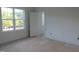 Bright bedroom with large windows and a door to another room at 1444 Old Apex Rd, Cary, NC 27513