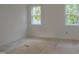 Sun-lit bedroom with two windows offering pleasant views, awaiting your personal touch at 1444 Old Apex Rd, Cary, NC 27513