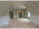 A bright, open bonus room features an inviting space with modern wainscoting and well-lit storage areas at 1444 Old Apex Rd, Cary, NC 27513