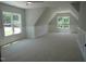 A large, bright bonus room with wainscoting and two windows offering ample natural light at 1444 Old Apex Rd, Cary, NC 27513