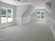 Large bonus room with two windows with charming wainscotting and soft carpeting for a relaxing feel at 1444 Old Apex Rd, Cary, NC 27513