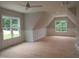 A spacious bonus room features ample natural light, wainscoting, and versatile open space for various activities at 1444 Old Apex Rd, Cary, NC 27513
