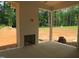 Covered patio with brick fireplace overlooking the verdant backyard at 1444 Old Apex Rd, Cary, NC 27513