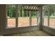 Bright dining area with large windows and modern chandelier, overlooks spacious outdoor area at 1444 Old Apex Rd, Cary, NC 27513