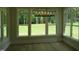 Bright dining area features large windows overlooking the landscaped lawn and a contemporary light fixture at 1444 Old Apex Rd, Cary, NC 27513