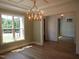 Elegant dining room featuring a chandelier, large window, and open access to other living spaces at 1444 Old Apex Rd, Cary, NC 27513
