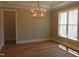 Formal dining room featuring elegant chandelier, large windows, and hardwood flooring at 1444 Old Apex Rd, Cary, NC 27513