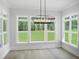 Dining room with hardwood flooring, large windows, and chandelier at 1444 Old Apex Rd, Cary, NC 27513