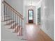 Beautiful home entryway featuring a staircase, wood flooring, and a view into the dining room at 1444 Old Apex Rd, Cary, NC 27513