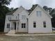 Beautiful two-story white brick house featuring a well-maintained lawn and classic architecture at 1444 Old Apex Rd, Cary, NC 27513