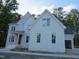 Charming two-story home with painted brick, side garage access, and mature trees at 1444 Old Apex Rd, Cary, NC 27513