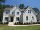 Stunning two-story brick home featuring manicured landscaping and a welcoming front entrance at 1444 Old Apex Rd, Cary, NC 27513