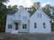 Elegant two-story home with a painted brick facade, multiple windows, and gabled rooflines at 1444 Old Apex Rd, Cary, NC 27513